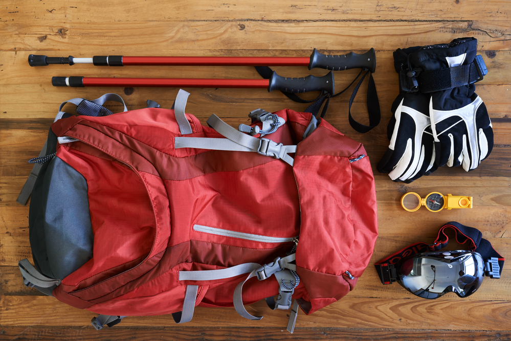 Shot of various tools and equipment for a hiker laid out on a table