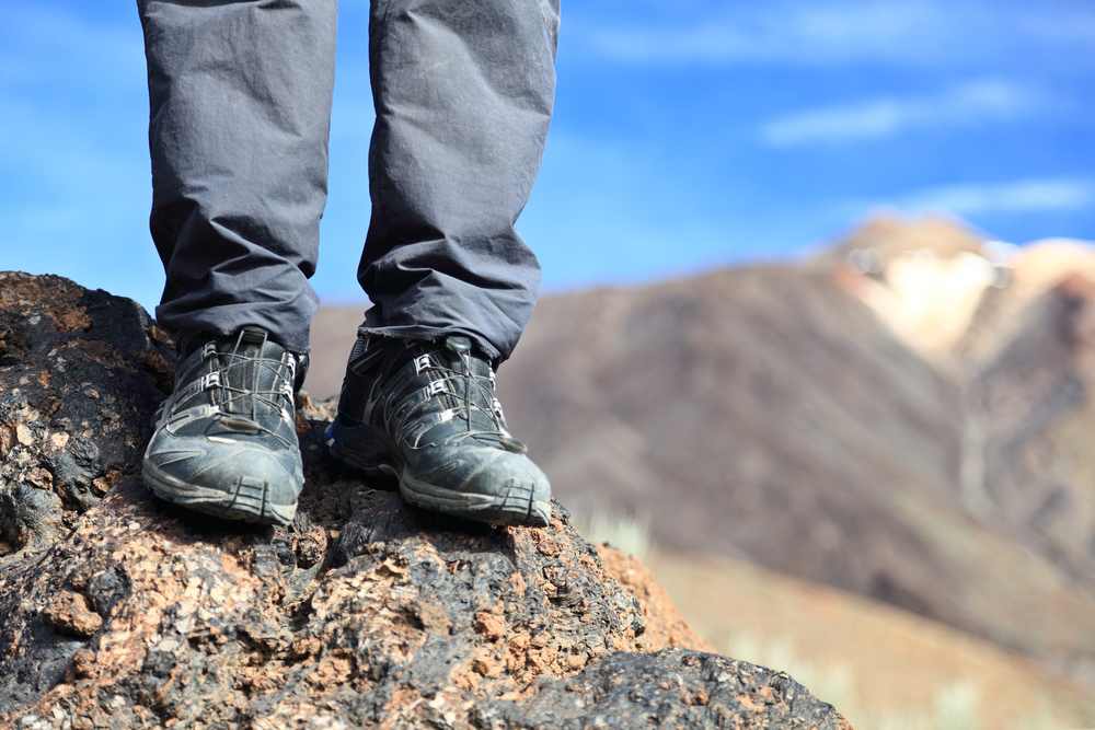 hiking boots / hiking shoes in mountain nature landscape